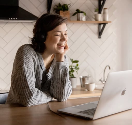 Woman participating in a video call, smiling and engaged, representing virtual communication