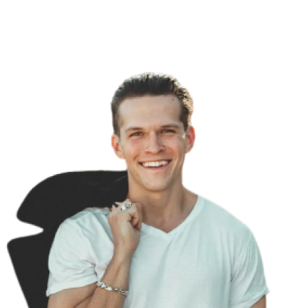 Young man wearing a white t-shirt holding a jacket
                    over his shoulder with a confident expression.